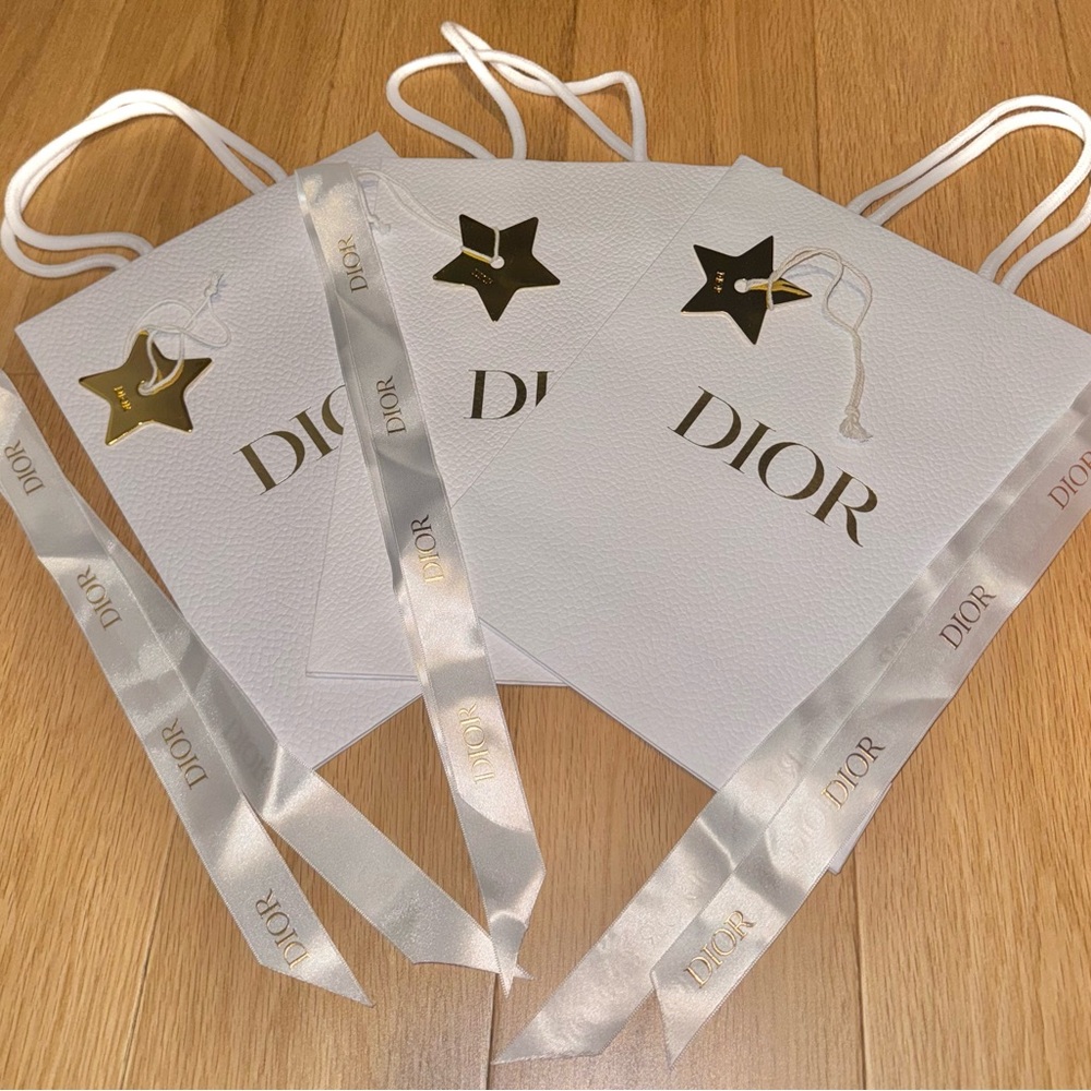 Dior white pebble shopping bag with ribbons and gold Dior stars